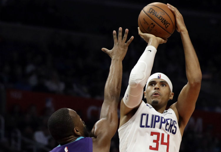 NBA: Tobias Harris attemps a three-point shot against Kemba Walker