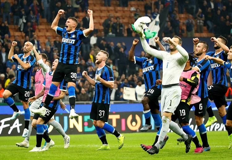 Inter Milan players celebrate with their fans after scoring their second goal at San Siro